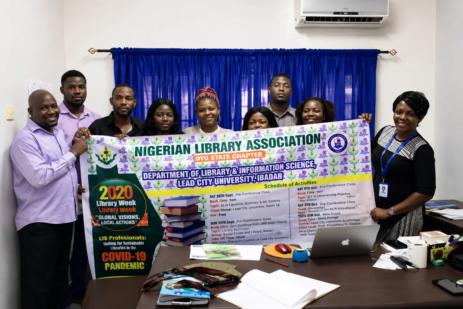 Members holding the 2020 Library Week banner